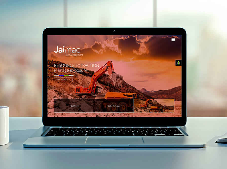 laptop on office table displaying jaimac website