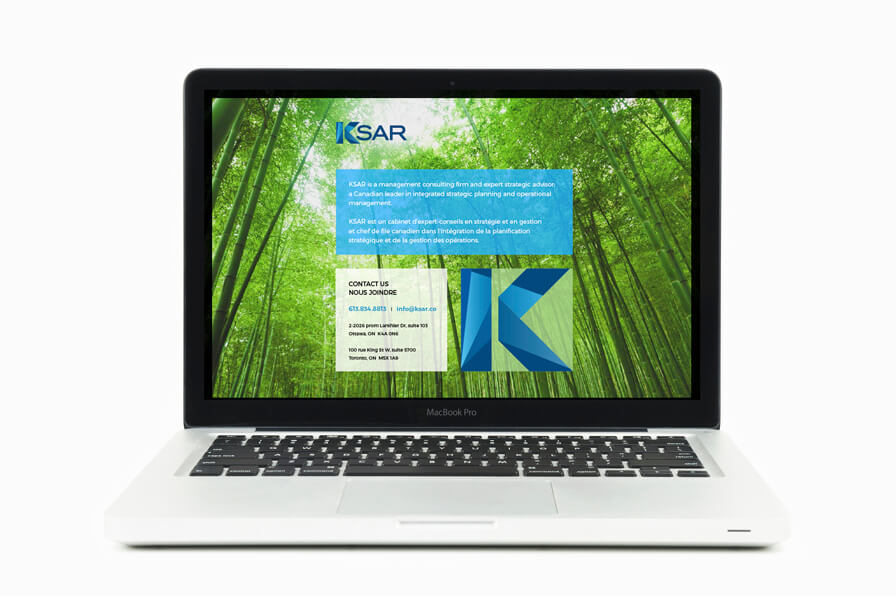 MacBook Pro on table displaying KSAR website