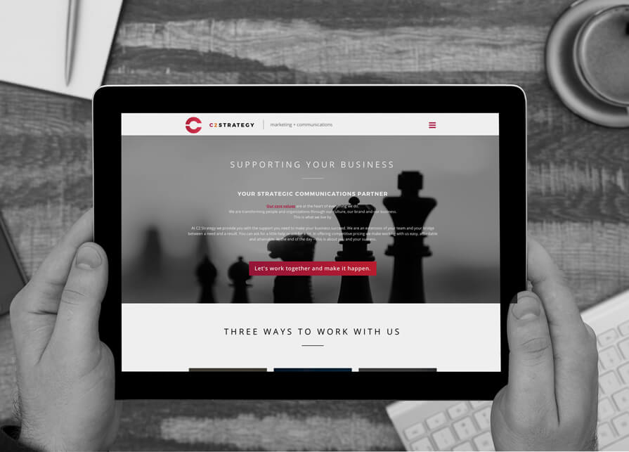 person holding tablet showing c2 strategy website